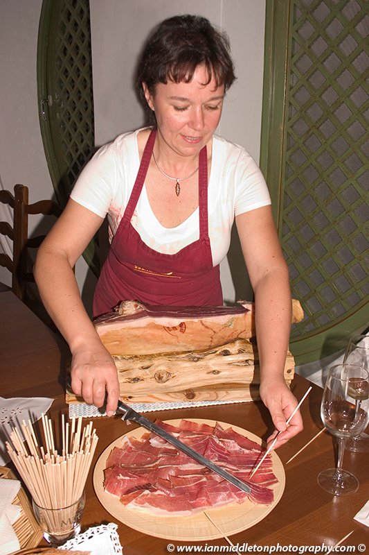 Cutting the famous Prsut (Karst Cured Ham) in Castle Dobrova