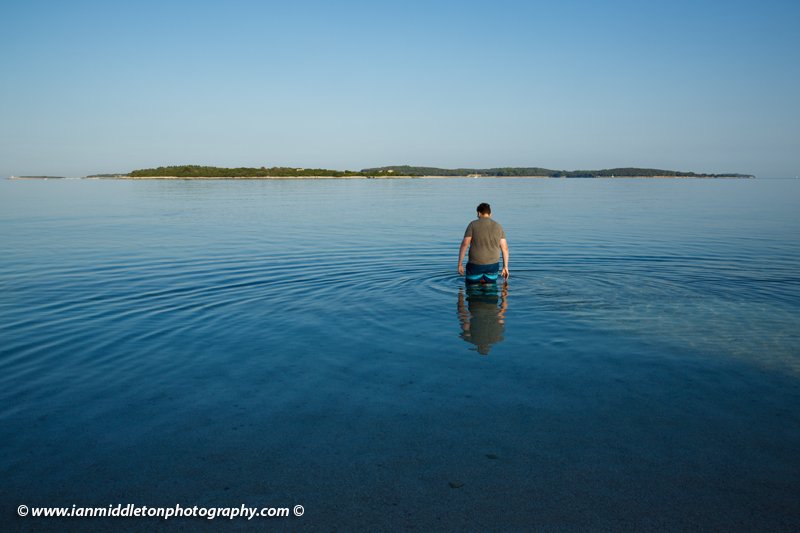 Heading out for a morning swim at Puntižela Beach with the Brijuni Islands in the background, Štinjan north of Pula.