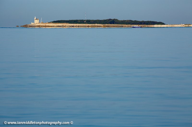 Lighthouse at the southern end of Veli Brijuni Island, Croatia. Seen from Puntižela Beach, Štinjan north of Pula.