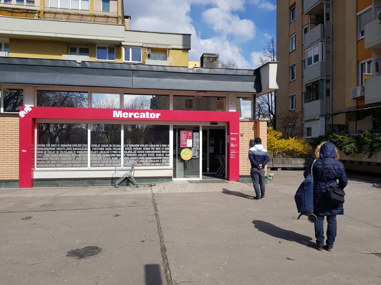 Queuing outside Mercator keeping safety distance in a suburb of Ljubljana, Slovenia. Mercator is Slovenia's main supermarket chain. Mercator is Slovenia's largest supermarket chain. Taken 23-3-2020