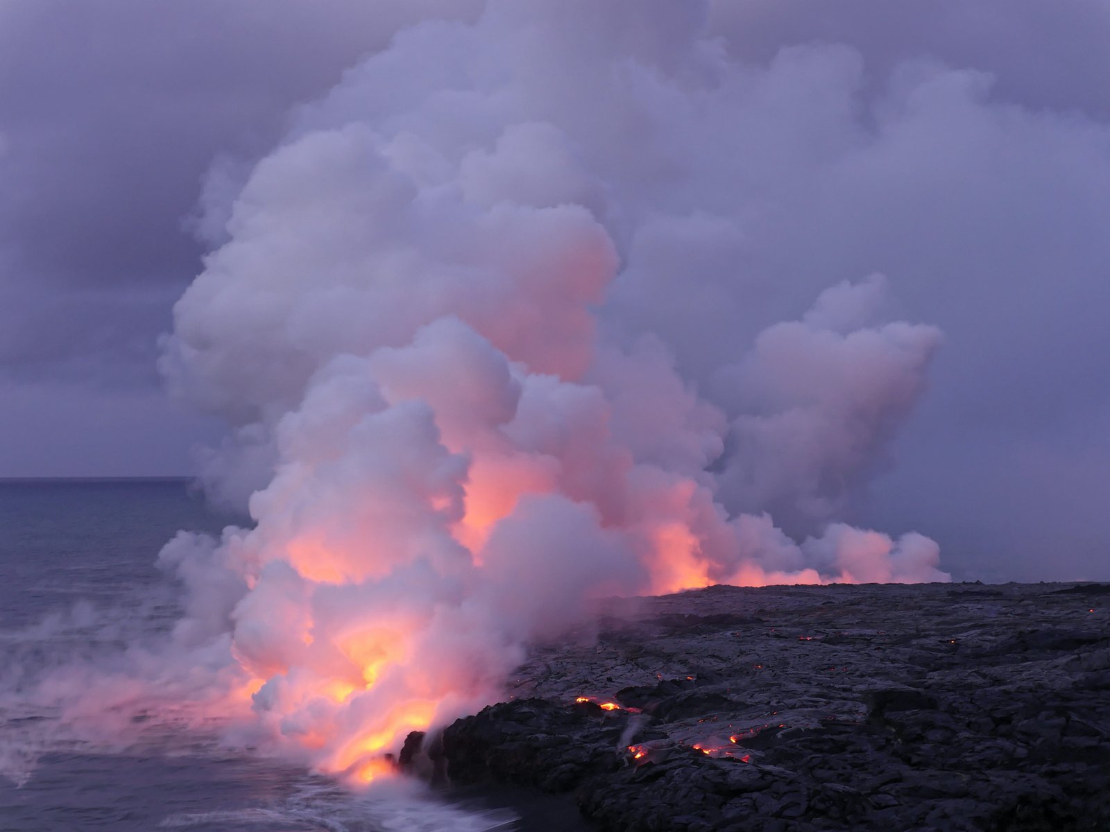 Lava flowing into the sea from Kilauea in Hawaii volcano national park. Photo by Marc Szeglat on Unsplash